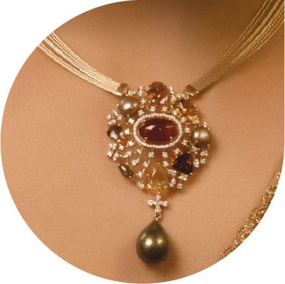 A trendy make a wish customized diamond necklace with pearls and gemstones.