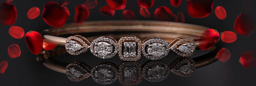 A diamond bracelet with rose petals is kept in front of a black background.