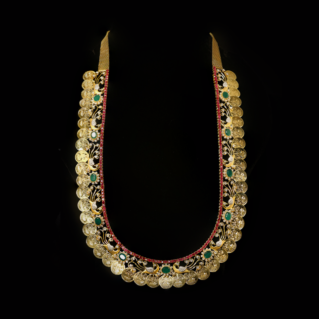 Traditional kaasu maalai, embellished with emerald, ruby and natural diamonds.