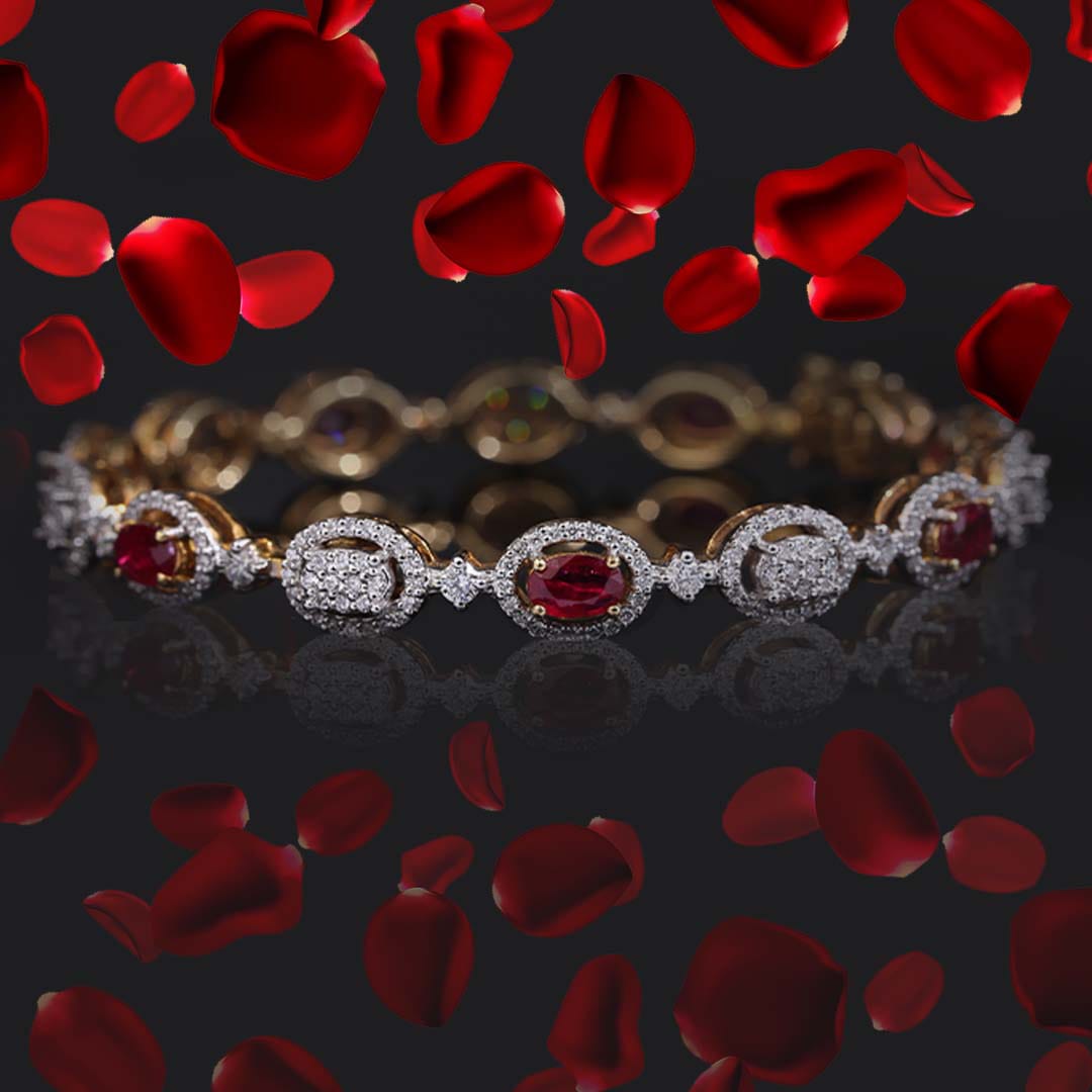 A diamond bangle piece with red stones is kept in the middle of the picture with rose pedals.