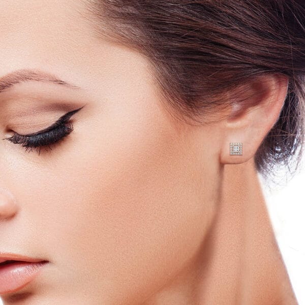 Human wearing the 0.15 ct Square Solitaire Diamond Earrings