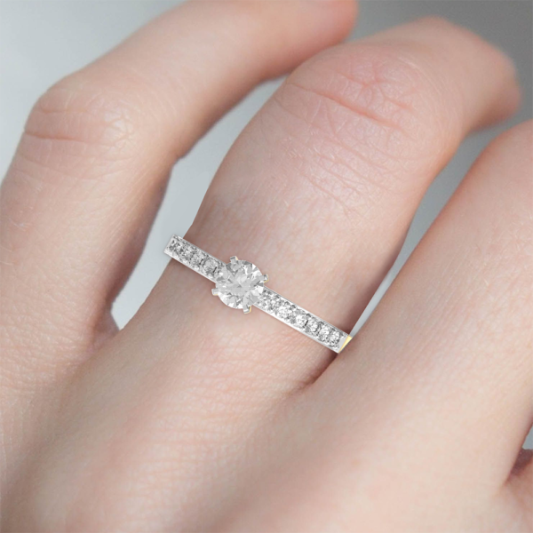 Human wearing the 0.30 Ct Lustrous Love Solitaire Diamond Engagement Ring