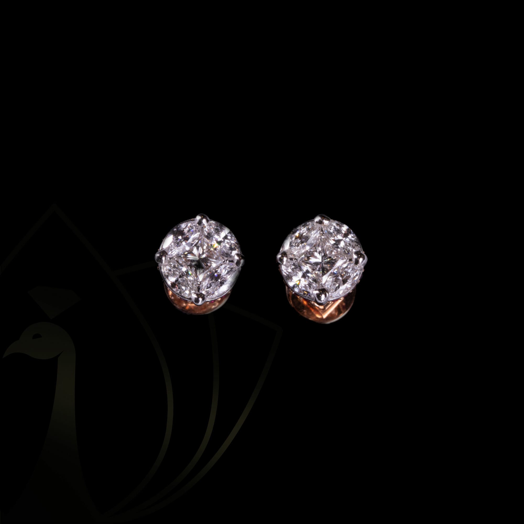 A pair of rounded radiance diamond earrings with solitaire diamonds.